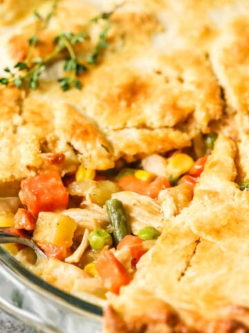 Slice of chicken pot pie removed to show the veggie filling inside.