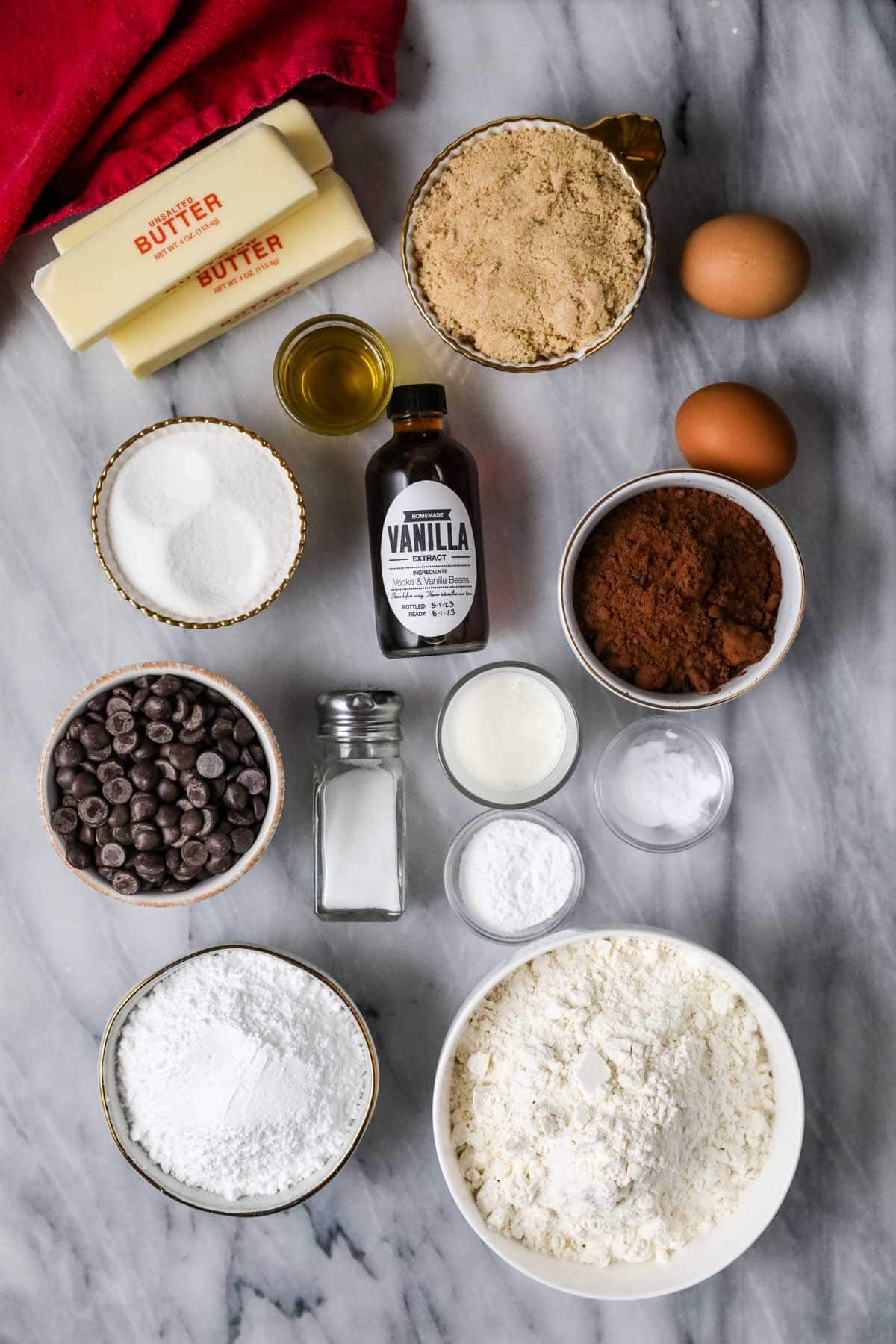 Overhead view of ingredients including cocoa powder, chocolate chips, cake flour, and more.