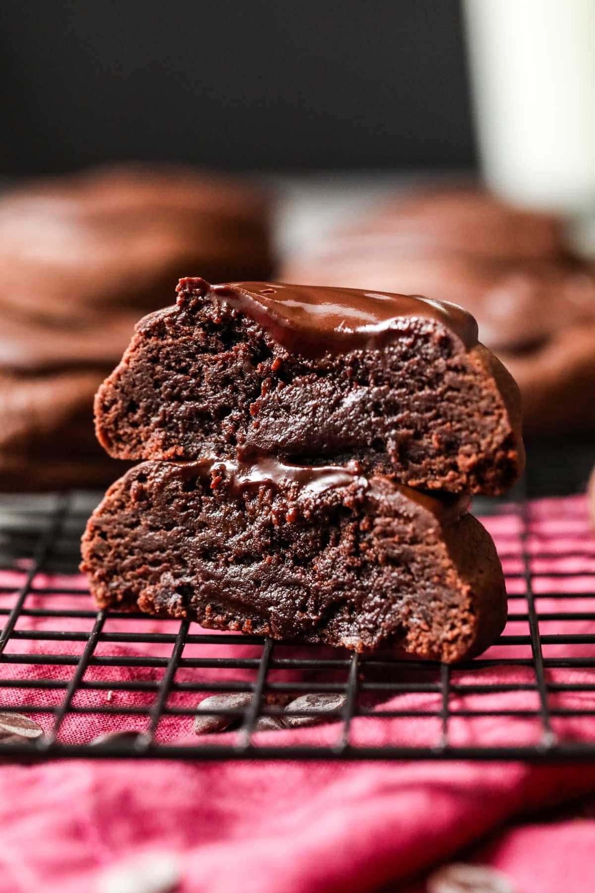 Two halves of a devil's food cookie stacked on top of each other to show a frosting center.