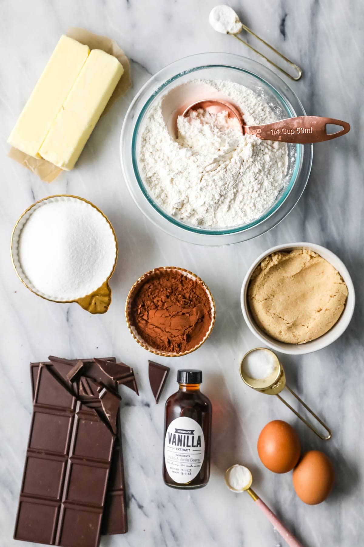 Overhead view of ingredients including flour, chocolate bars, cocoa powder, and more.