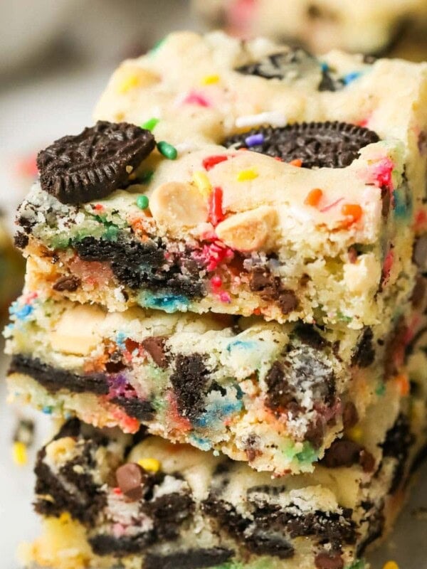 Stack of three funfetti Oreo bars punctuated with bits of Oreo cookies and sprinkles.