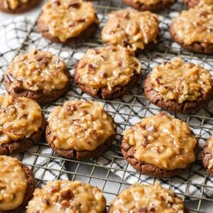 Rows of German chocolate cookies on a cooling rack.