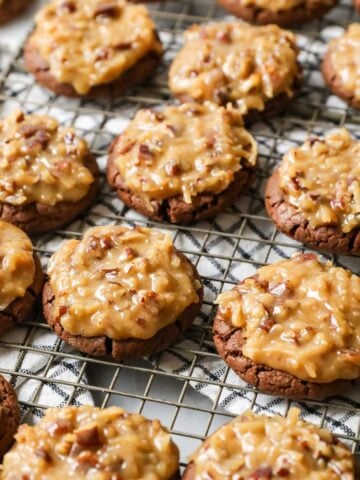 Rows of German chocolate cookies on a cooling rack.