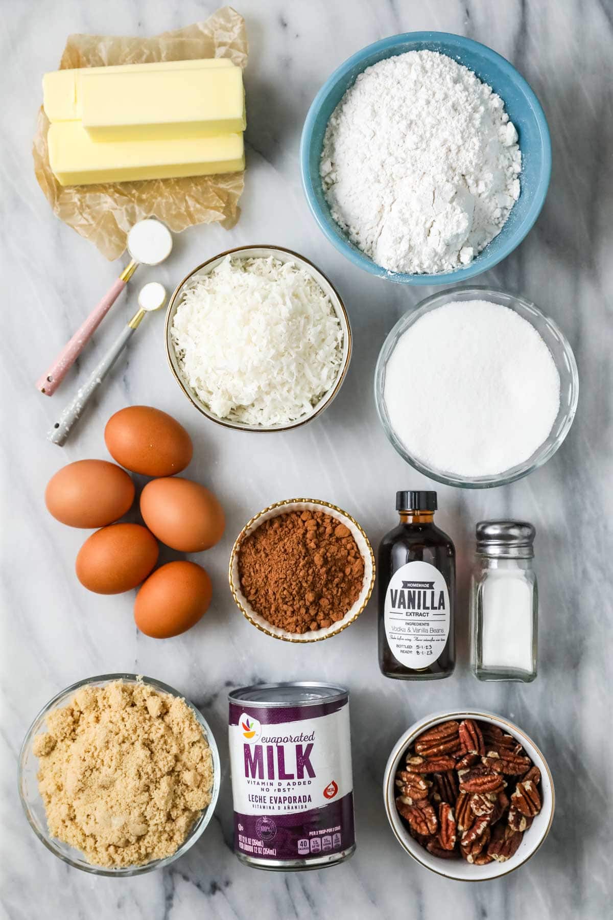 Overhead view of ingredients including cocoa powder, evaporated milk, coconut, and more.