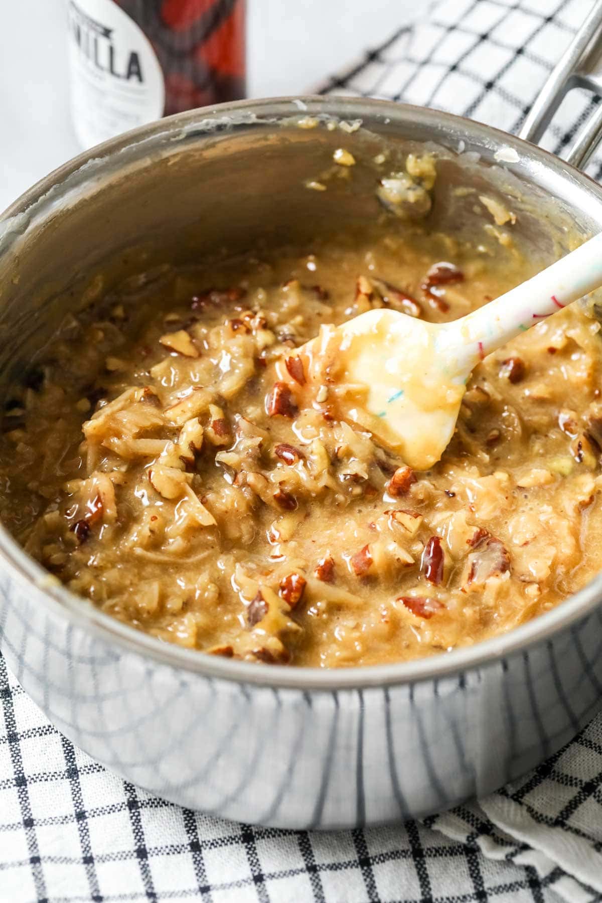 Pot of a coconut caramel topping for German chocolate cookies.