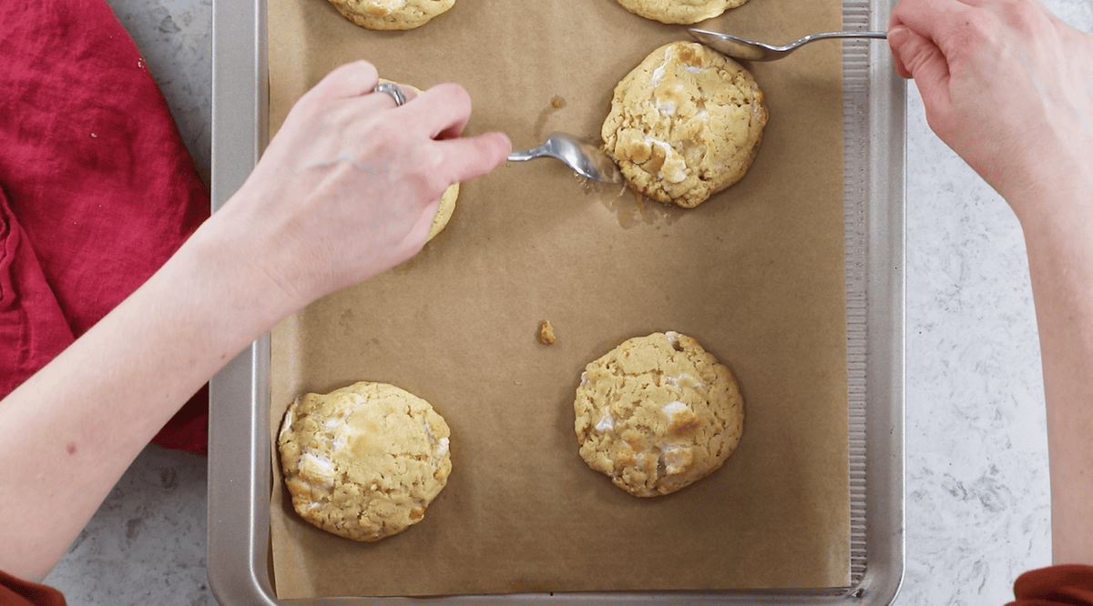 Spoons rounding rice krispie cookies after baking.