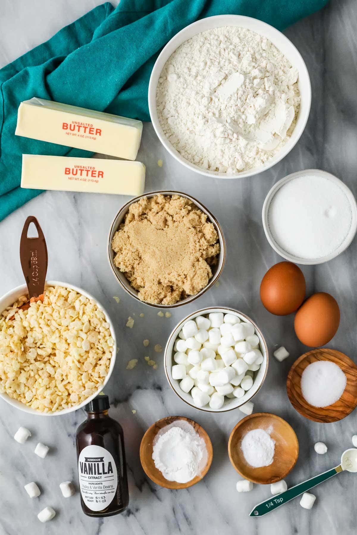 Overhead view of ingredients including rice krispies cereal, brown sugar, flour, and more.