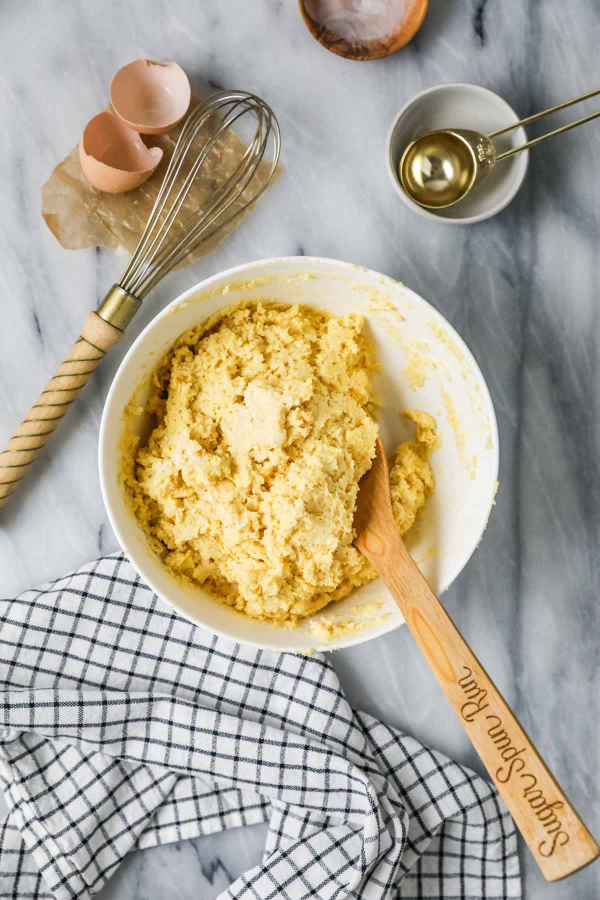 Overhead view of a bowl of batter for making corn muffins.