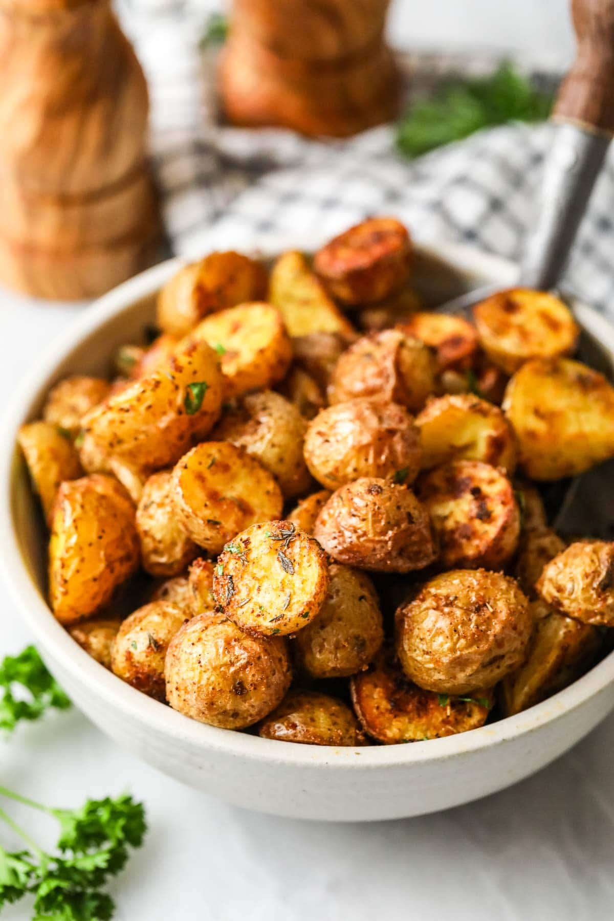 Bowl of crispy and golden brown oven roasted potatoes.