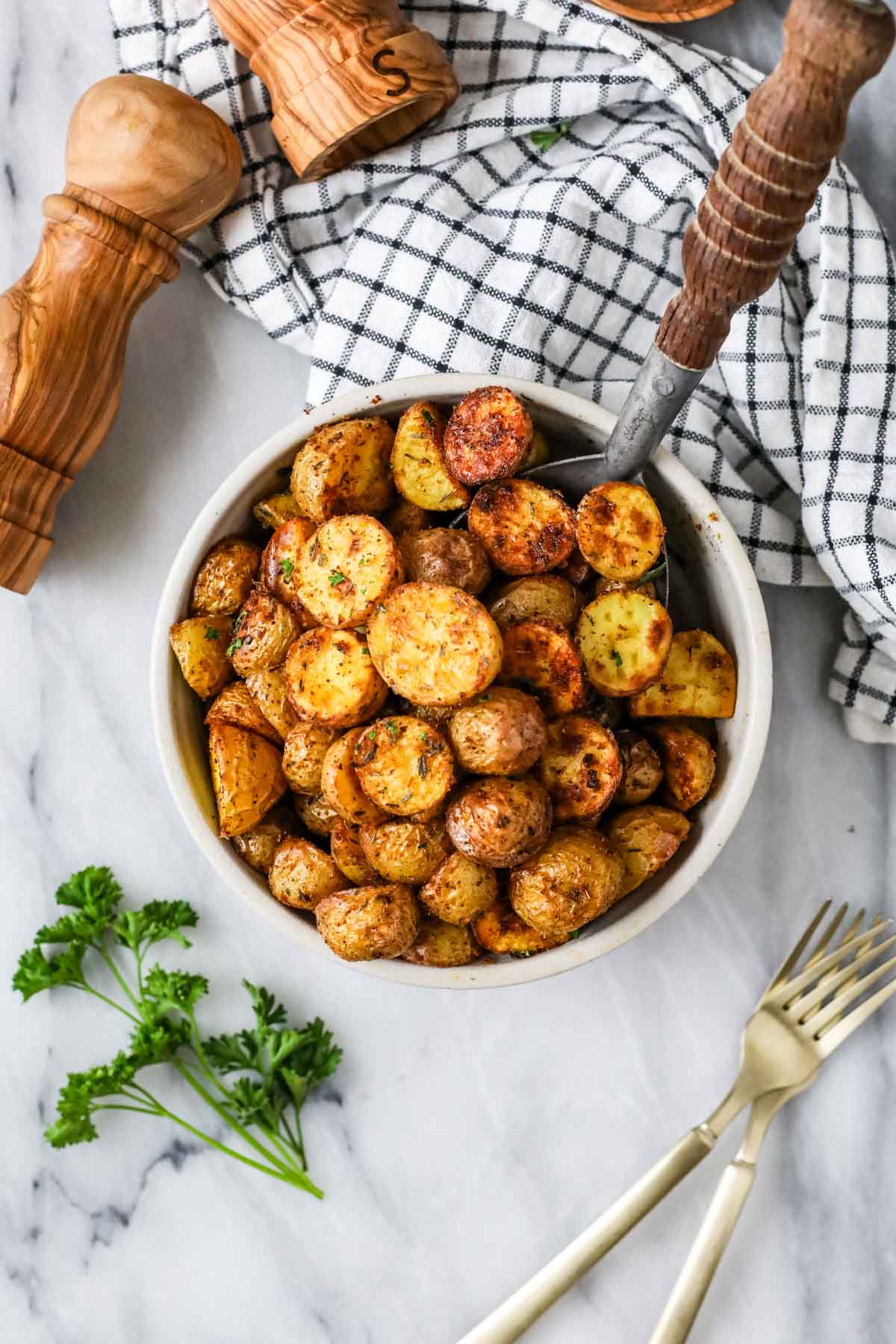 Top view of a bowl of small oven baked potatoes.