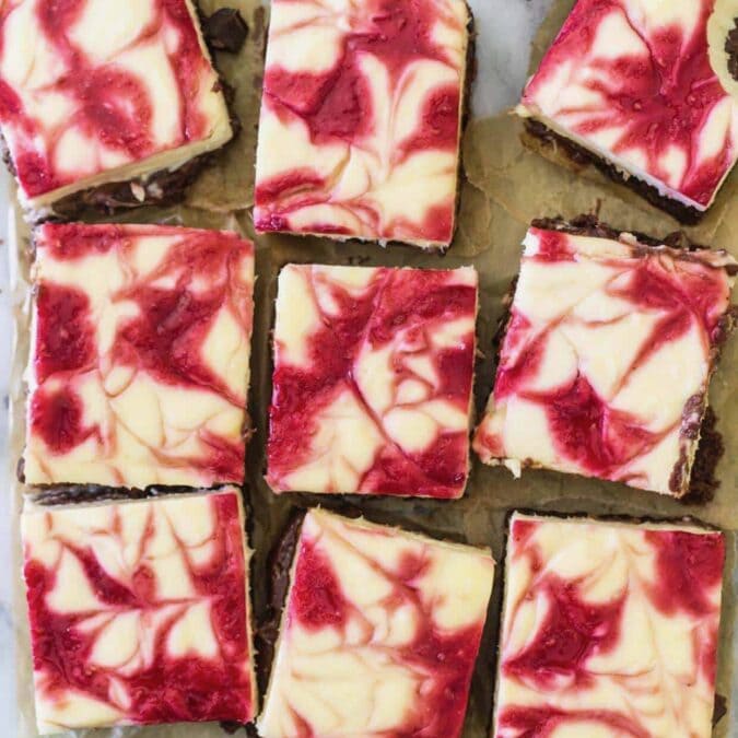 Overhead view of raspberry cheesecake brownies after cutting.