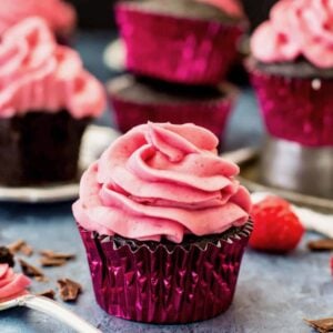 Chocolate raspberry cupcake in a shiny pink foil wrapper.