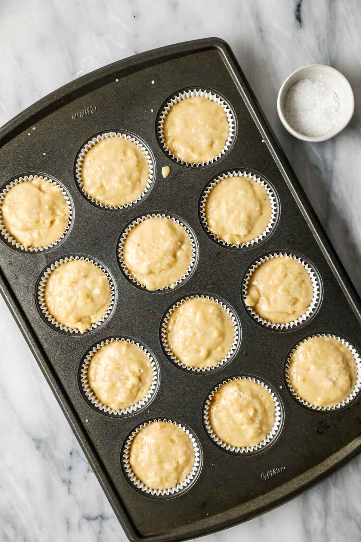 Elevated landscape of sourdough muffin pan before baking.