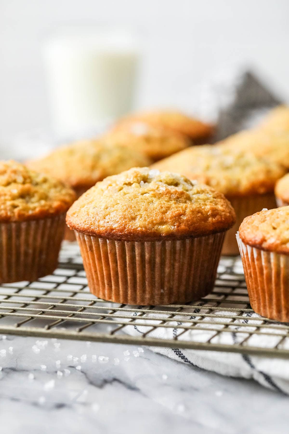 A row of sour noodles banana muffins lined up on the cooling rack.