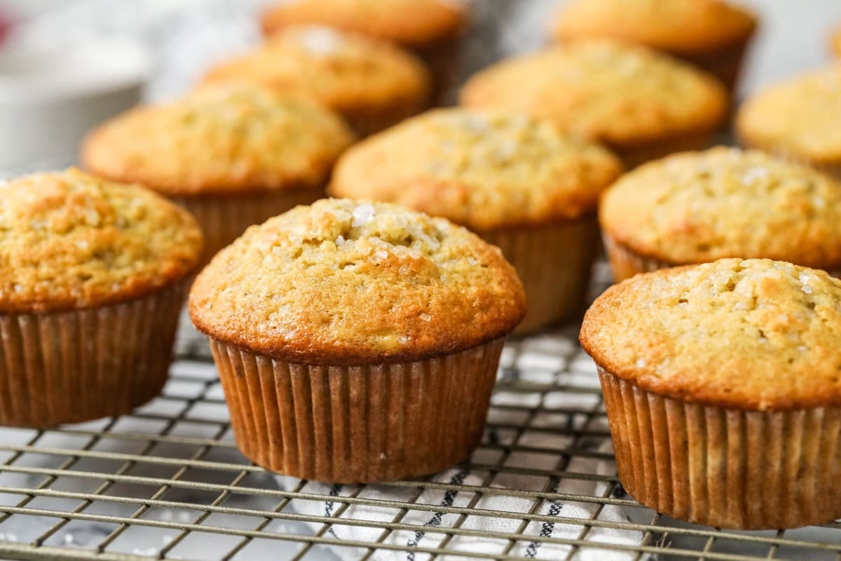 A row of sour noodles banana muffins lined up on the cooling rack.