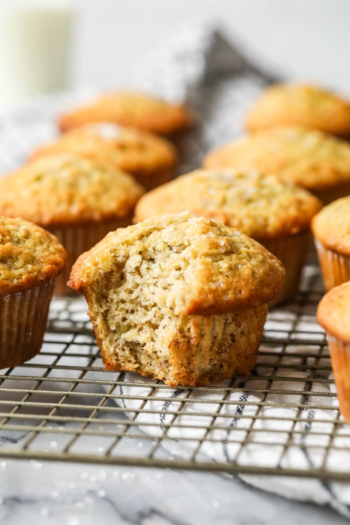 Take a bite into the sour banana muffin on the cooling rack.