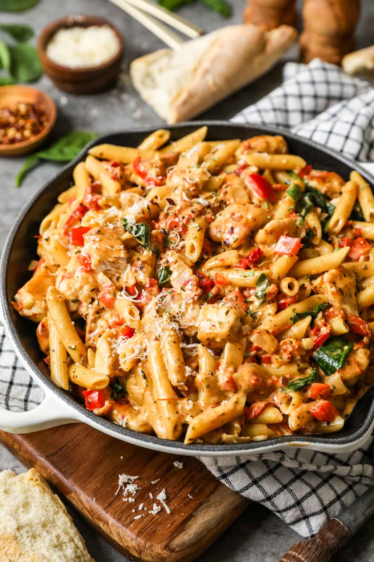 Skillet of tuscan chicken pasta made with spinach and sun dried tomatoes.