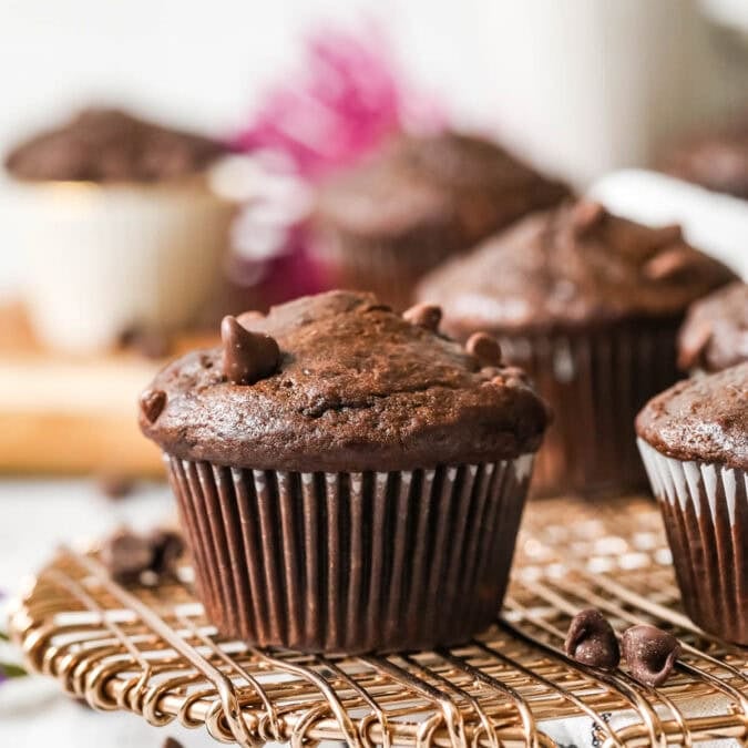 Chocolate banana muffins on a cooling rack.