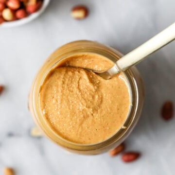 Overhead view of a jar of homemade peanut butter.