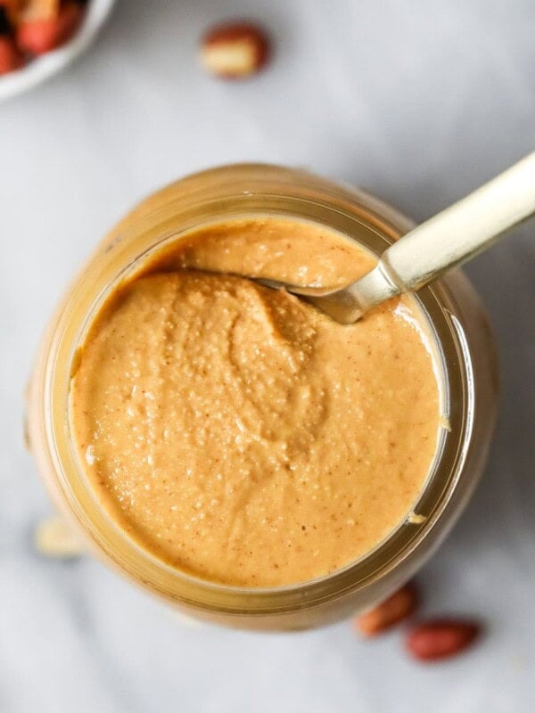 Overhead view of a jar of homemade peanut butter.
