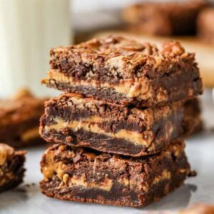 Stack of three peanut butter brownies with a distinct peanut butter layer inside and swirled tops.