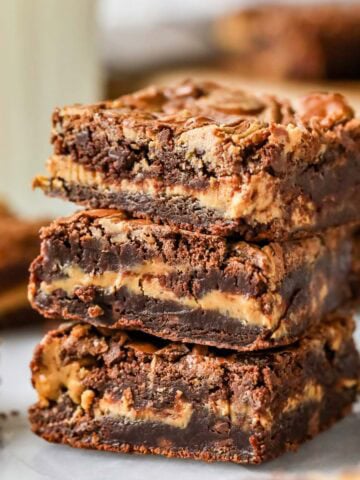 Stack of three peanut butter brownies with a distinct peanut butter layer inside and swirled tops.