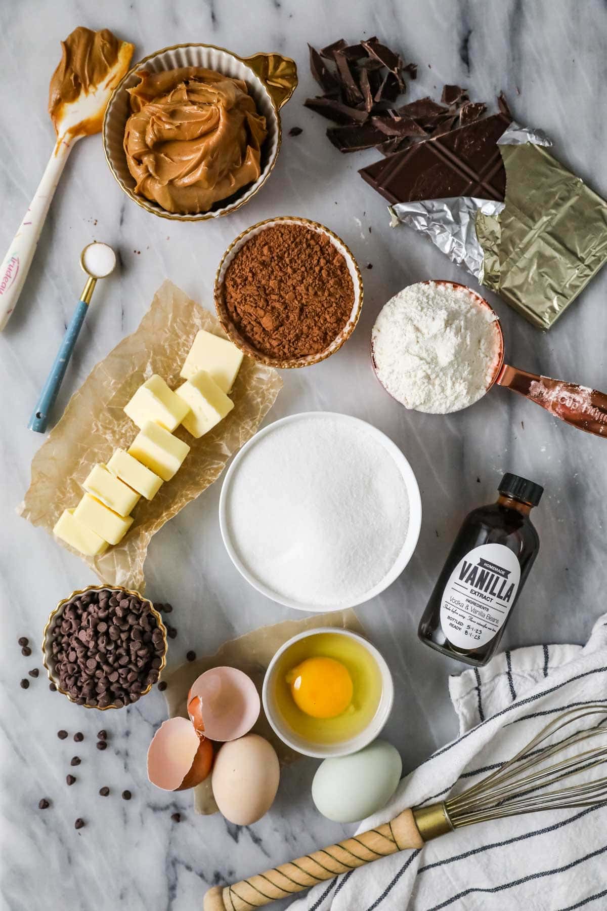 Overhead view of ingredients including butter, peanut butter, cocoa powder, and more.