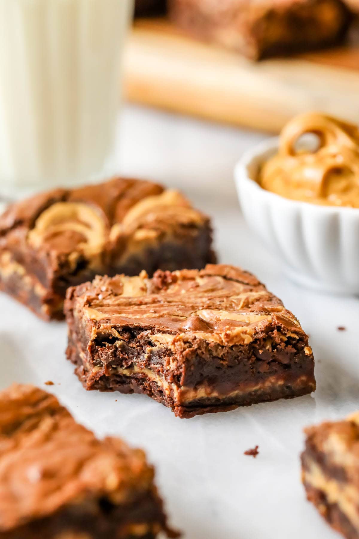 Bite missing from a brownie with a peanut butter center and swirled peanut butter top.