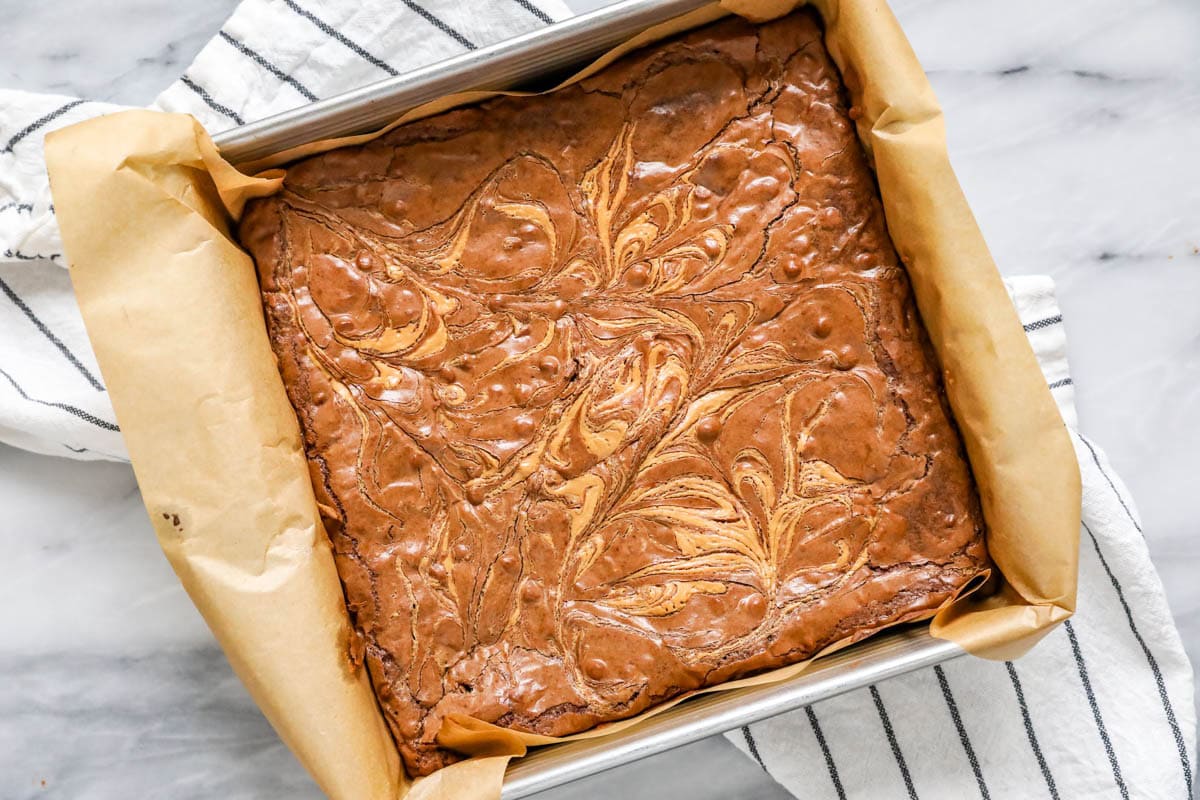 Overhead view of a pan of brownies with a swirled peanut butter top after baking.