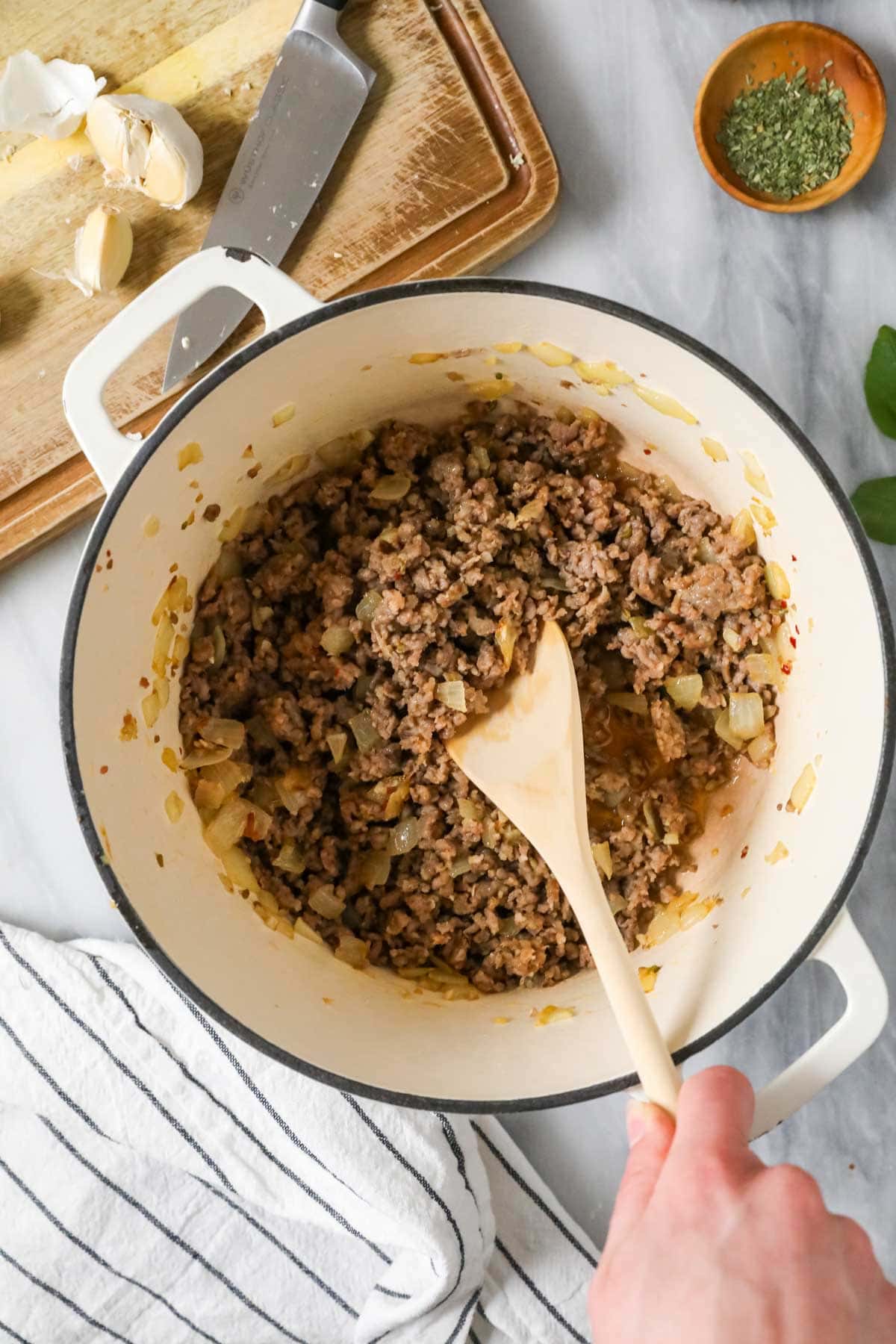 Overhead view of browned and crumbled sausage in a pot.