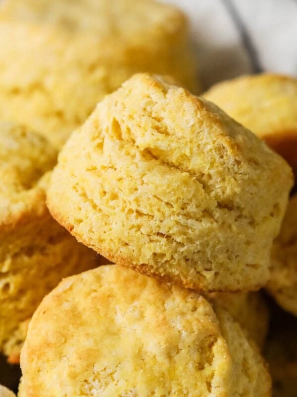 Tall cornbread biscuits with flaky layers in a pile.