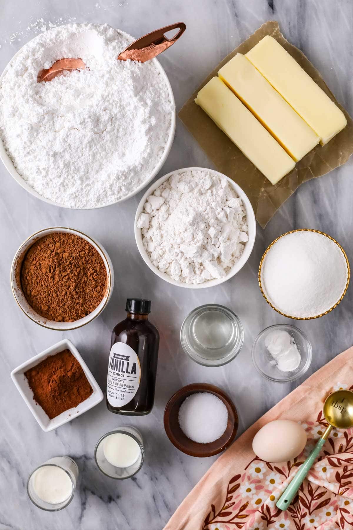 Overhead view of ingredients including cake flour, cocoa powder, butter, and more.