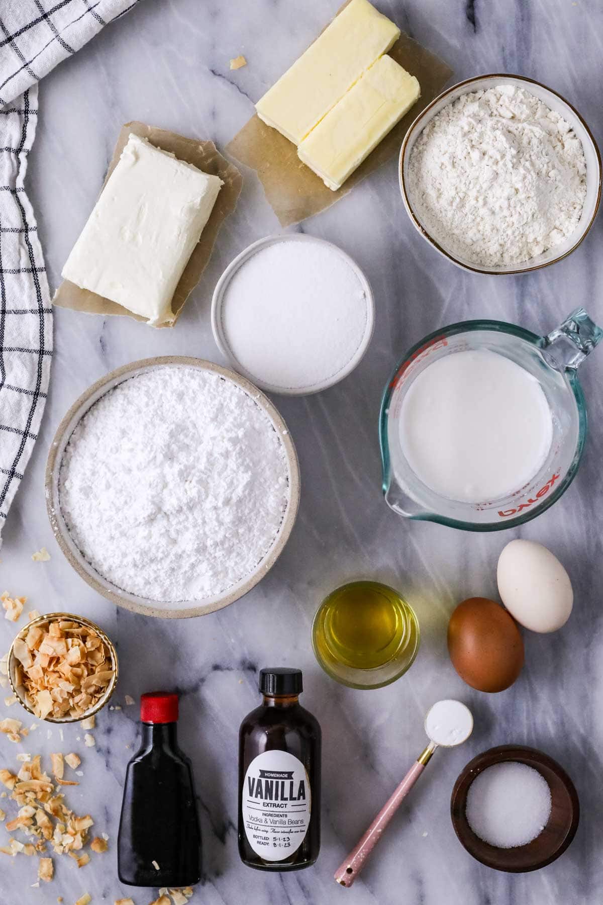 Overhead view of ingredients including coconut, cream cheese, coconut milk, and more.