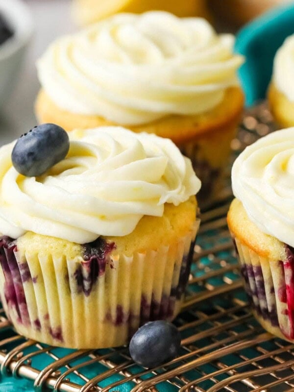 Lemon blueberry cupcakes on a cooling rack.