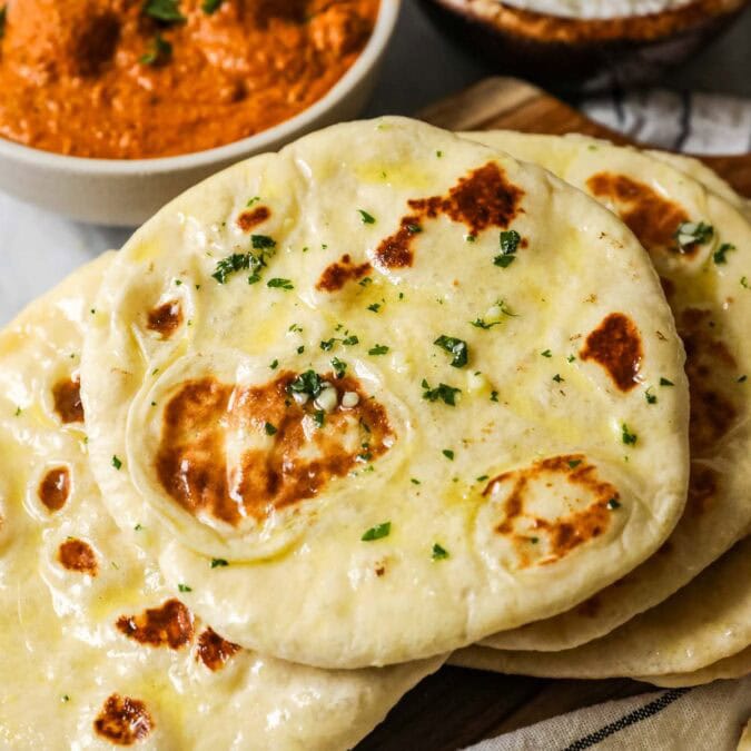 Pile of homemade naan including garlic naan.