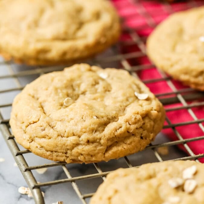 Peanut butter oatmeal cookies cooling on a gold cooling rack