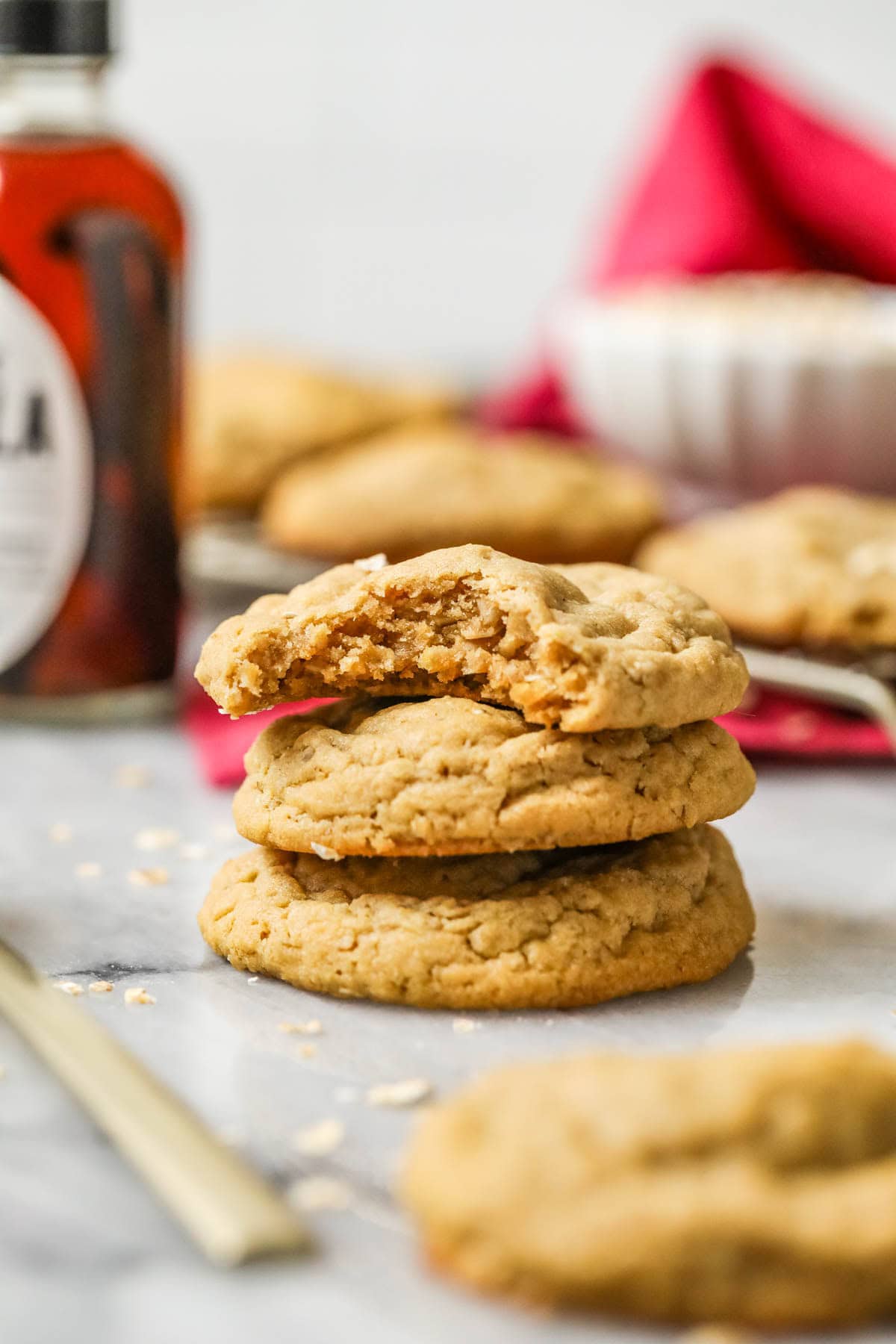 stack of 3 peanut butter oatmeal cookies, one with a bite missing