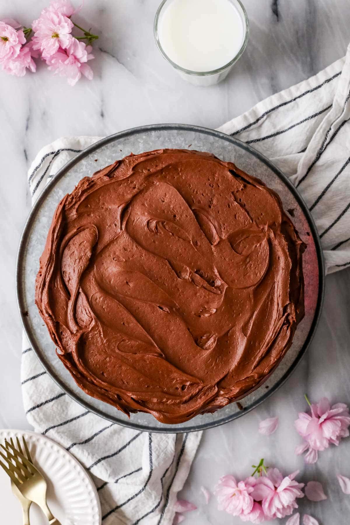 Overhead view of a cake frosted with a chocolate sour cream frosting.