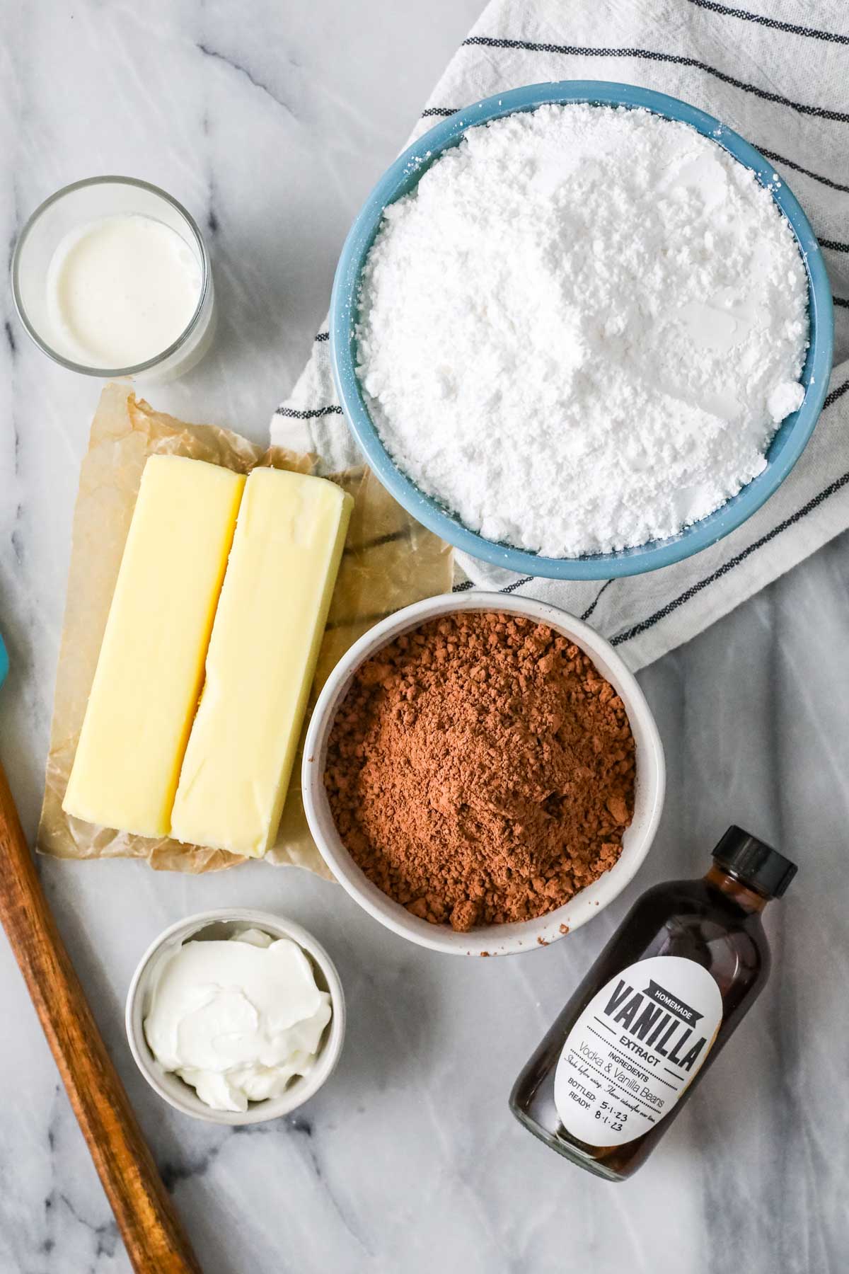 Overhead view of ingredients including butter, cocoa powder, sour cream, and more.