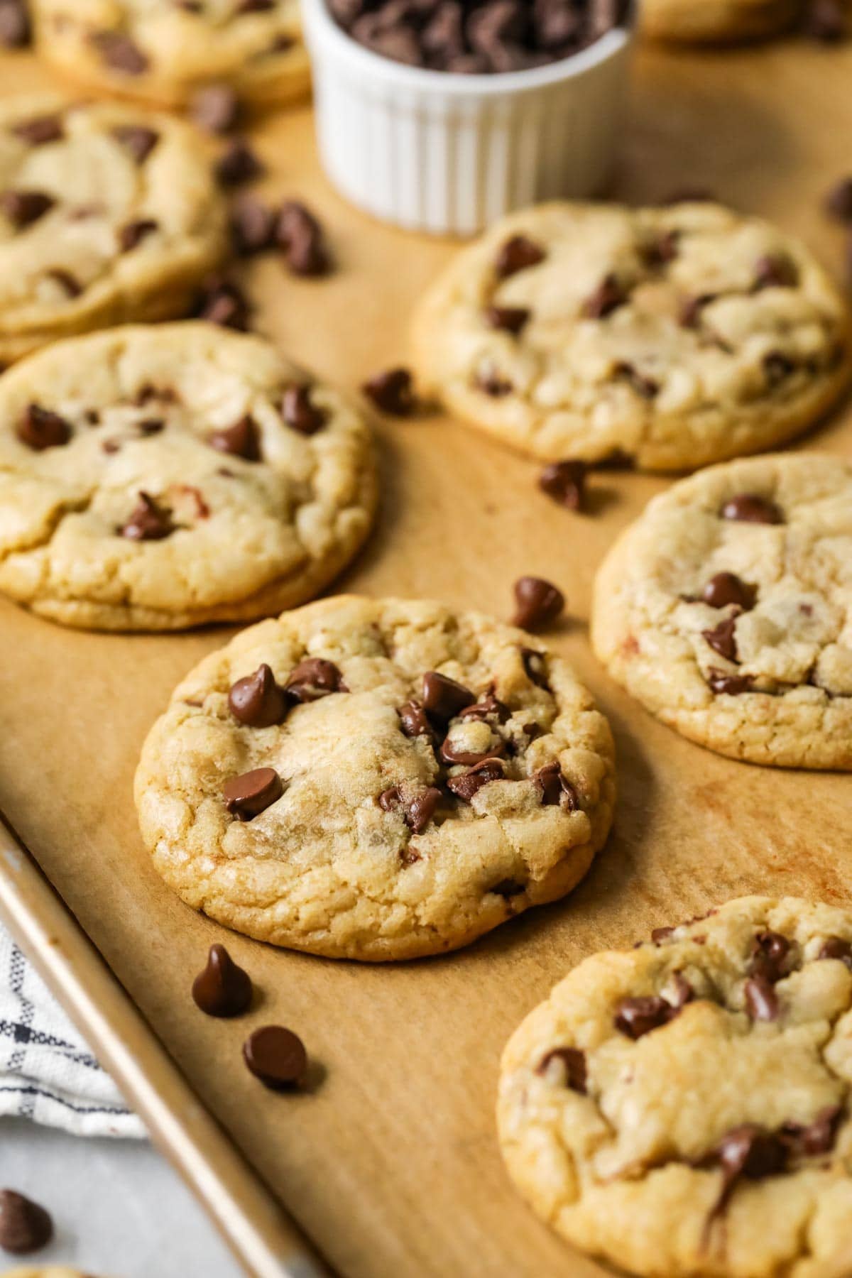 Baking sheet of cookies made with chocolate chips.