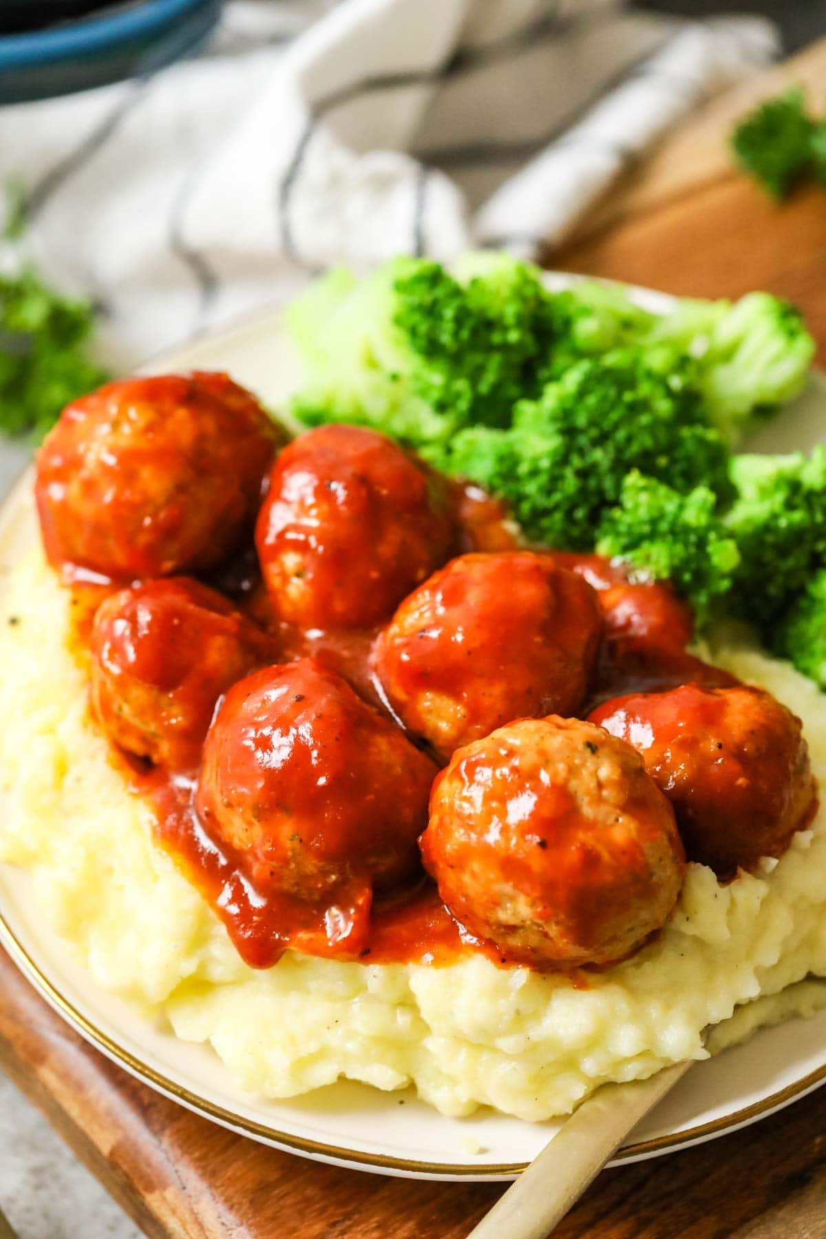 BBQ chicken meatballs served over mashed potatoes with a side of broccoli.