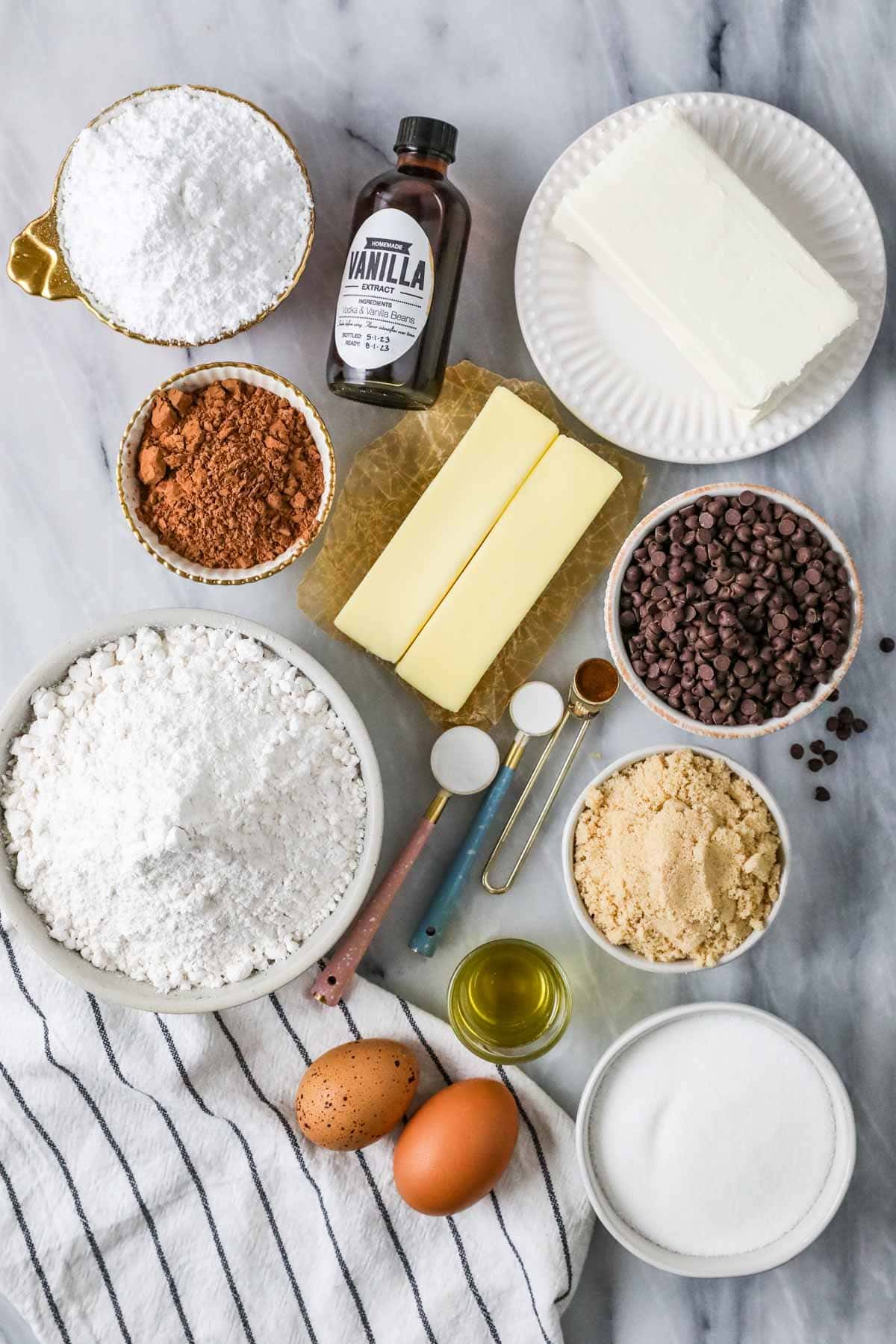 Overhead view of ingredients including cocoa powder, cream cheese, cake flour, and more.