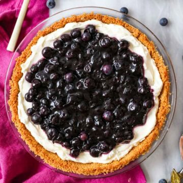 Overhead view of a blueberry cream cheese pie in a graham cracker crust.