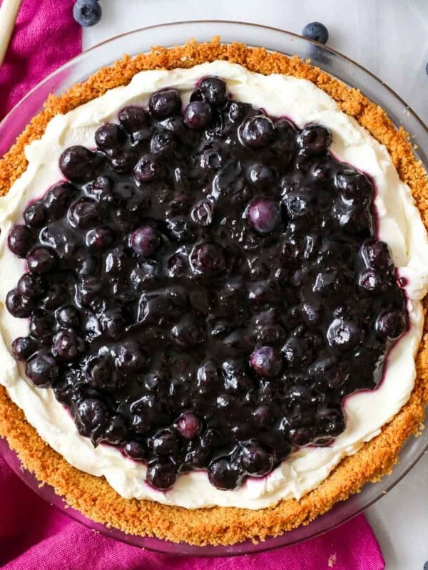 Overhead view of a blueberry cream cheese pie in a graham cracker crust.