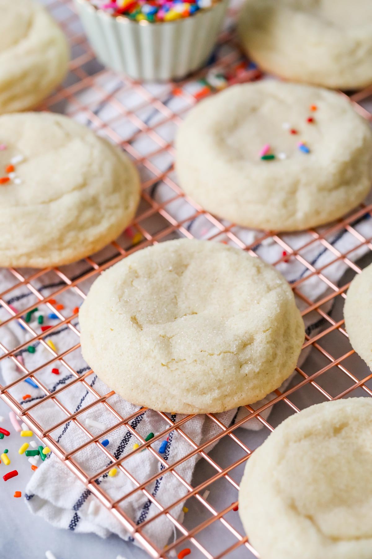 Thick, gourmet-style sugar cookies on a cooling rack.