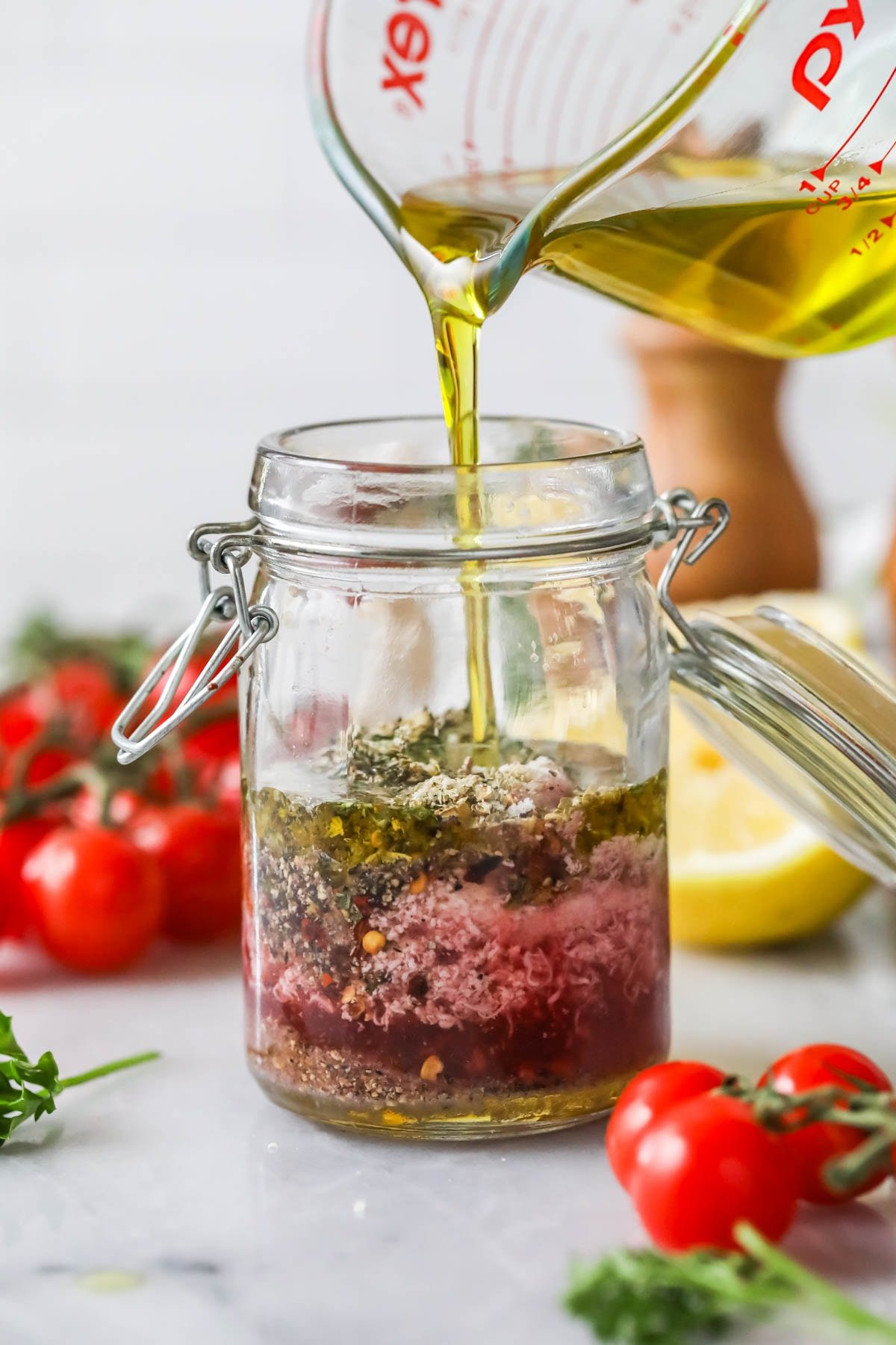 Pour olive oil into a can of spices, vinegar, mustard, etc.