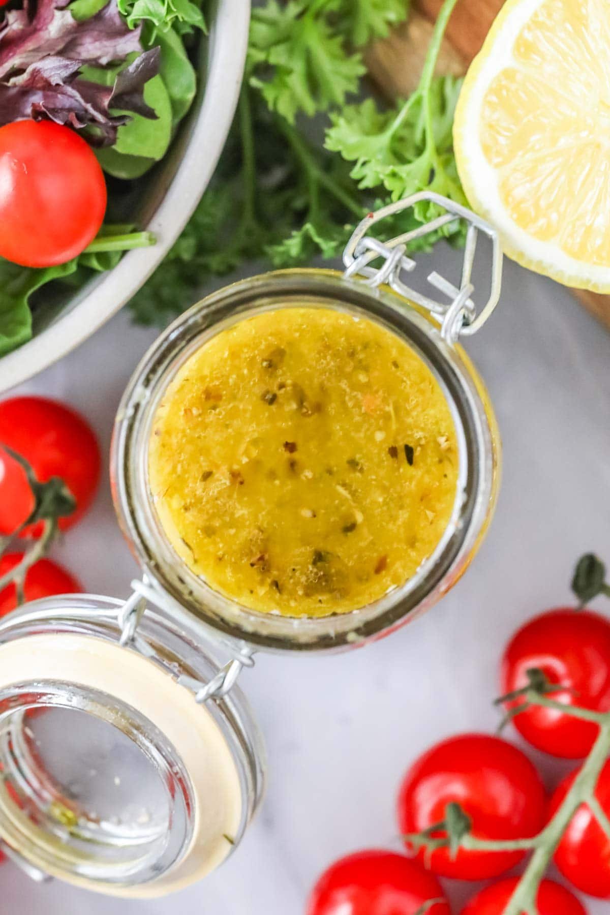 Elevated view of a can of homemade dressing made from oregano, basil, parmesan cheese and more.