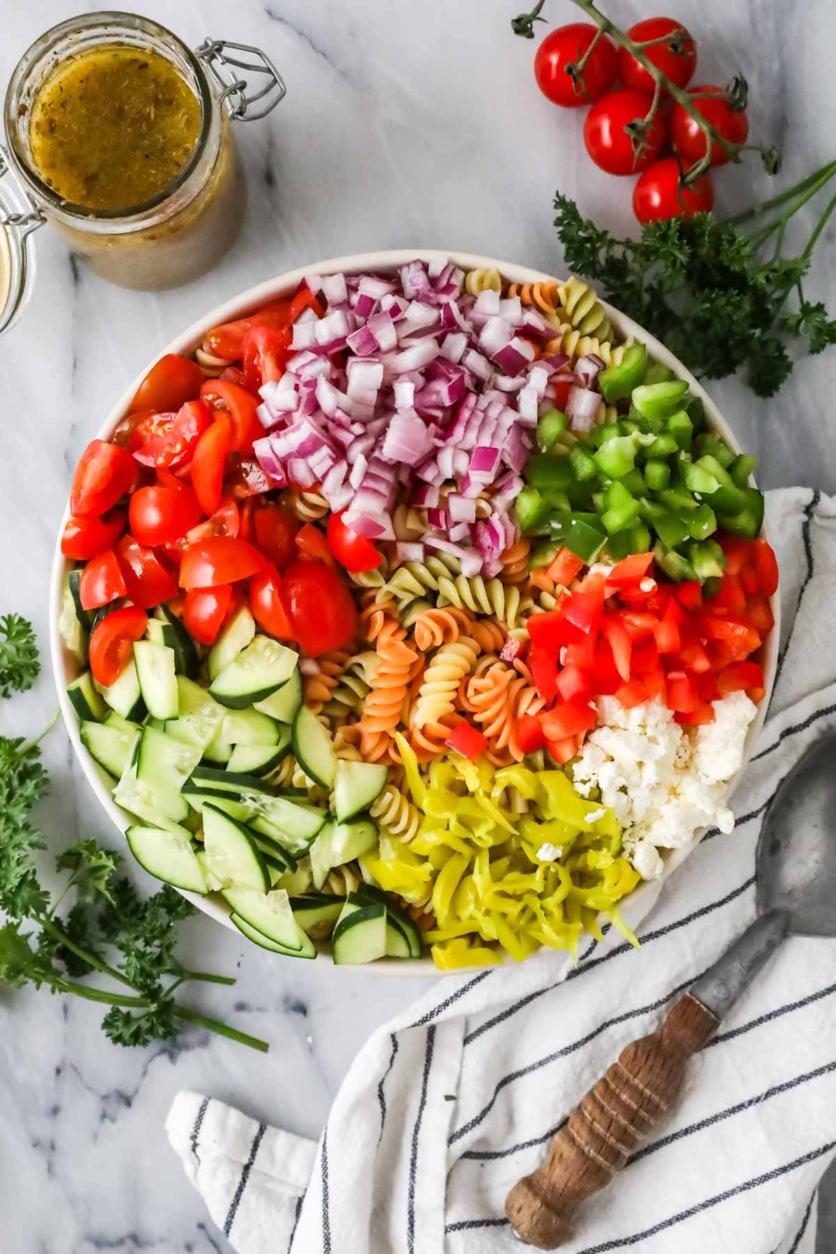 Enjoy the overhead view of vegetables and pasta in a bowl before mixing.