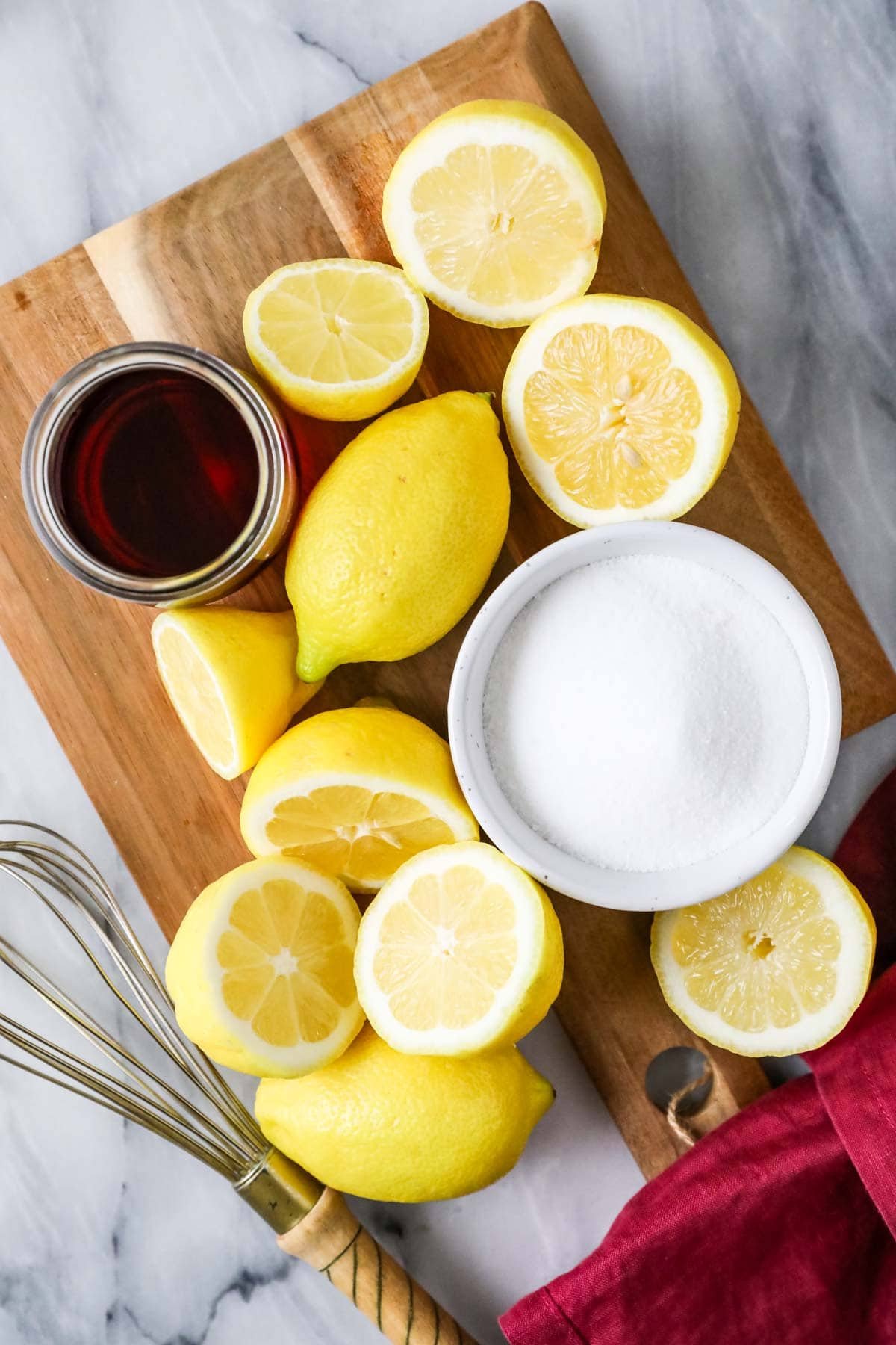 Elevated landscape with ingredients including lemon, sugar and cranberry juice.