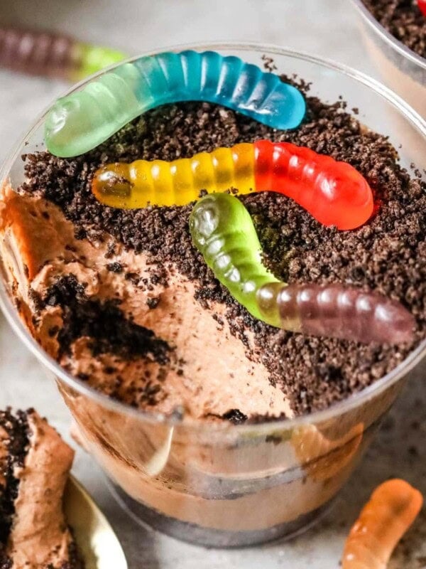 Overhead view of a cup of dirt pudding with one bite missing.